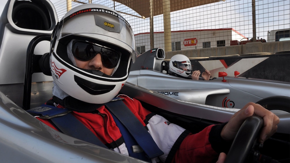 close up of man in race car driving in Abu Dhabi