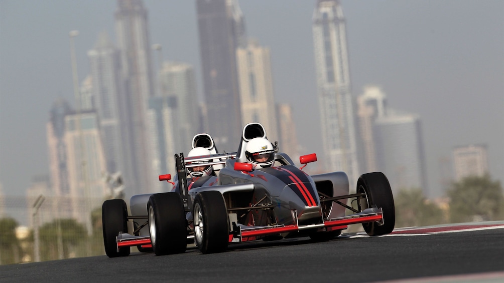 two race cars race on track in Abu Dhabi