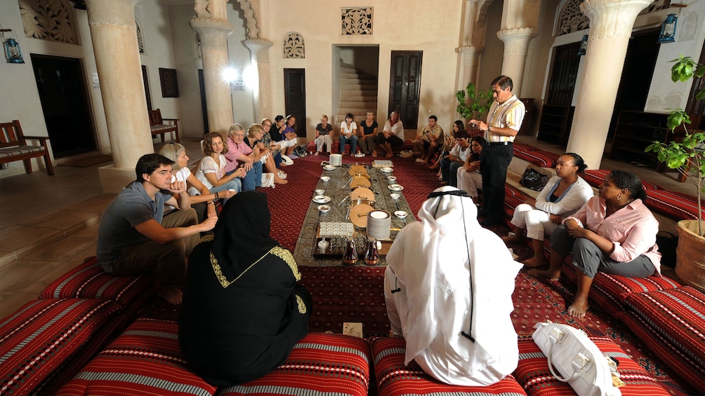 large group gathering around room for Emirati dinner in Abu Dhabi