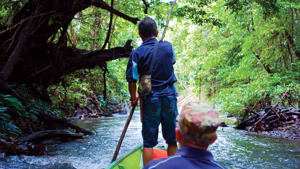 Show item 5 of 5. Man enjoys a scenic float down the river at Ulu Temburong National Park