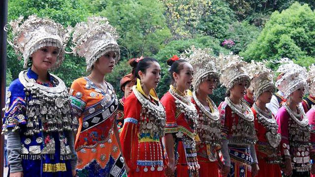 women in elaborate traditional outfits in Guilin