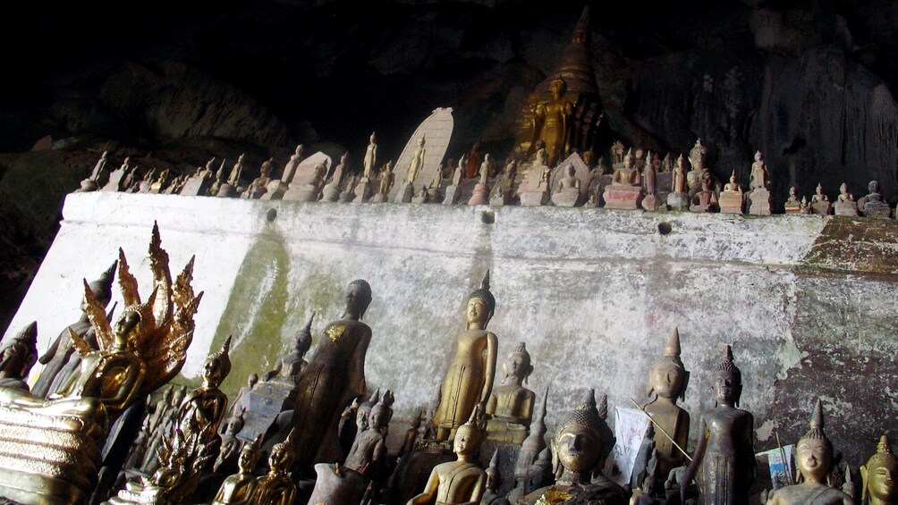 An assortment of Buddha statues inside the Pak Ou Caves