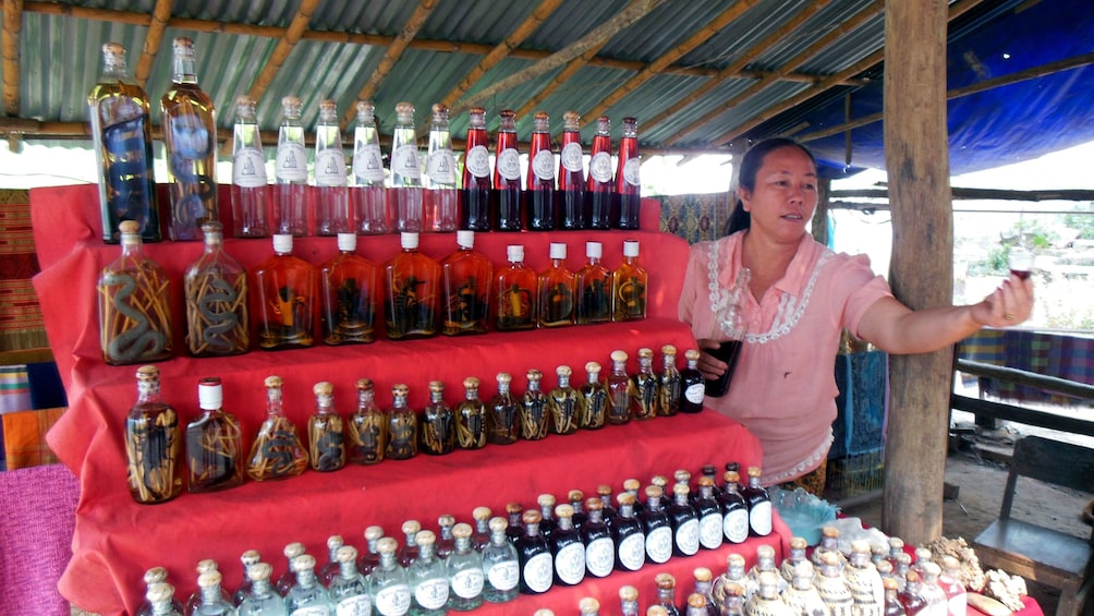 A woman selling ancient remedies just outside the Pak Ou Caves 