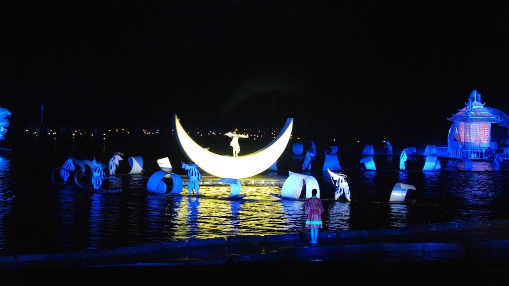 singer performing on stage props on water in Guilin
