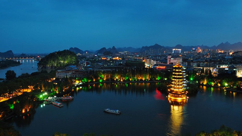 illuminated establishments along the river at dusk in Guilin