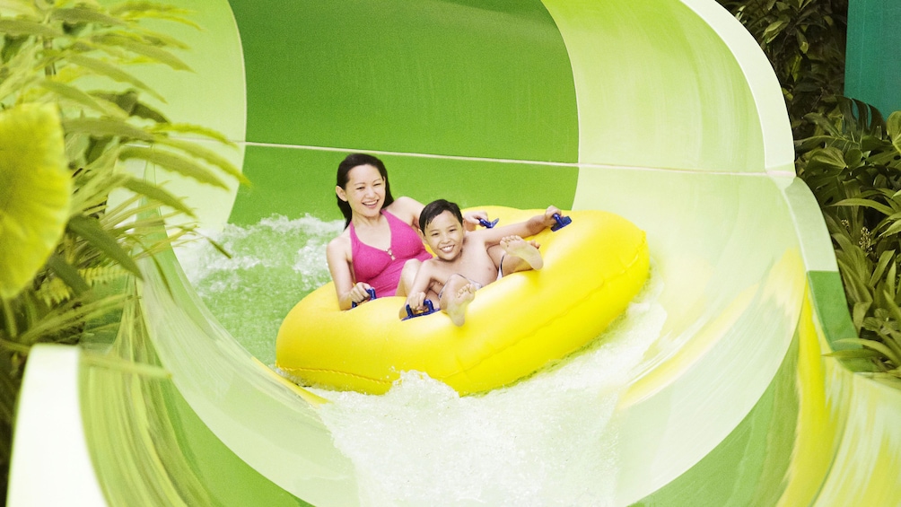 Mother and sone on waterslide at the adventure cove waterpark in Singapore 