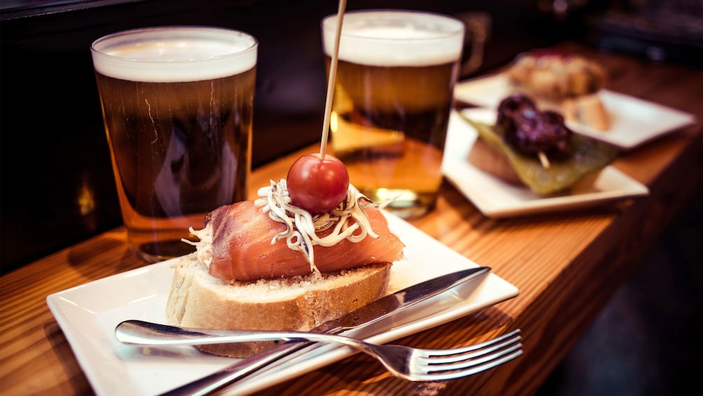 plate of smoked salmon  and beer at food tour in Barcelona