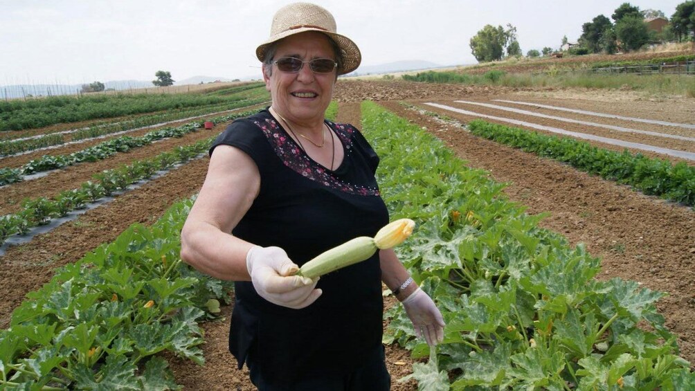Lady smiling in front of a garden in Italy