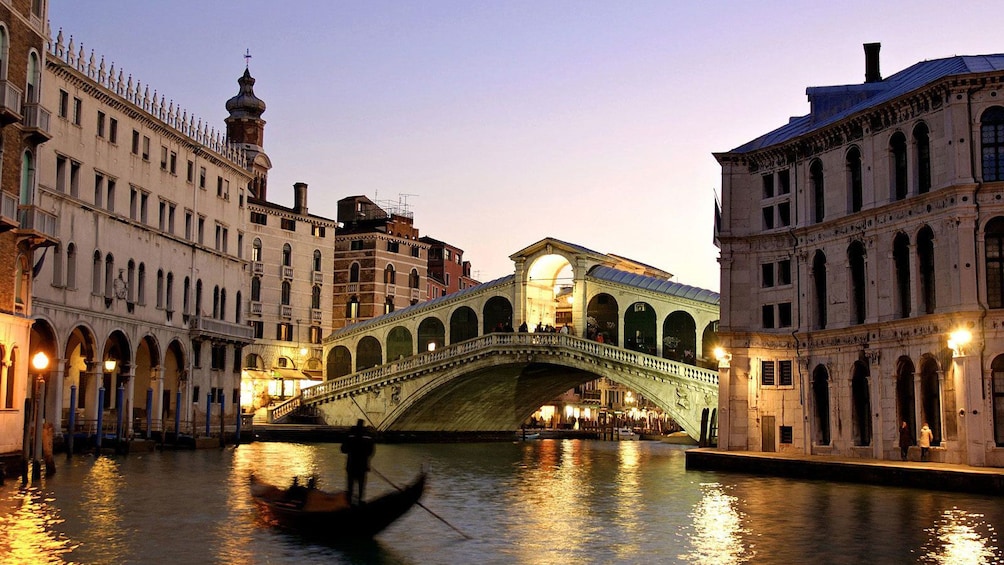 Lights on a an arched bridge at sunset in Venice Italy 