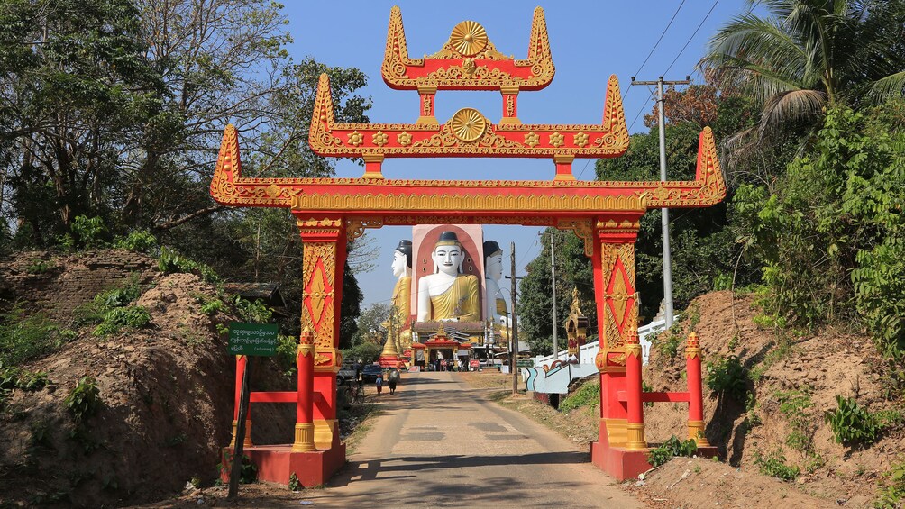 Large ornate arch over a road leading to the Four Seated Buddha shrine in Bago