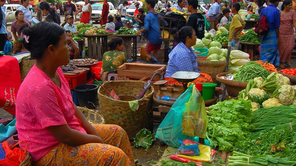 Fruit and vegetable stalls at an open-air market in Syriam