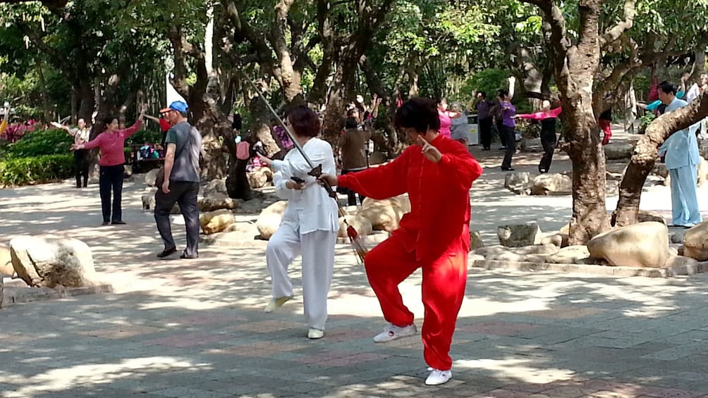 Show item 4 of 7. Martial artists at the park in Hong Kong