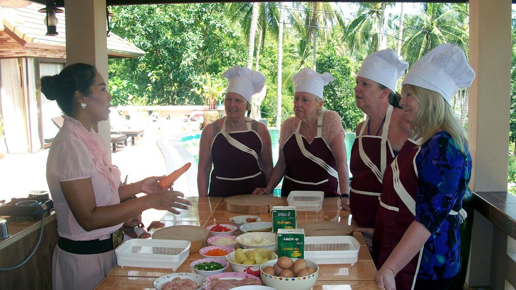 An instructor talking to students at Chanita Thai Cooking School in Koh Samui