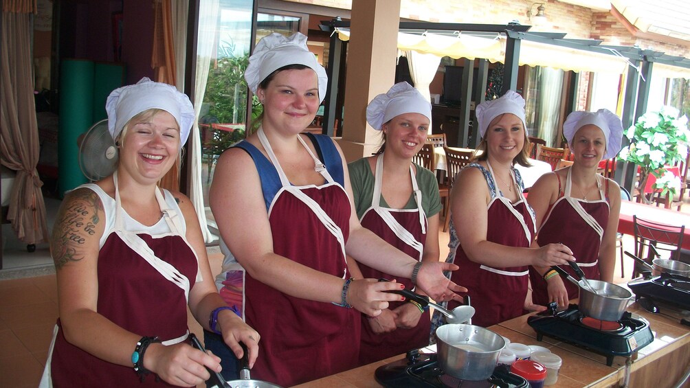 Students cooking at Chanita Thai Cooking School in Koh Samui