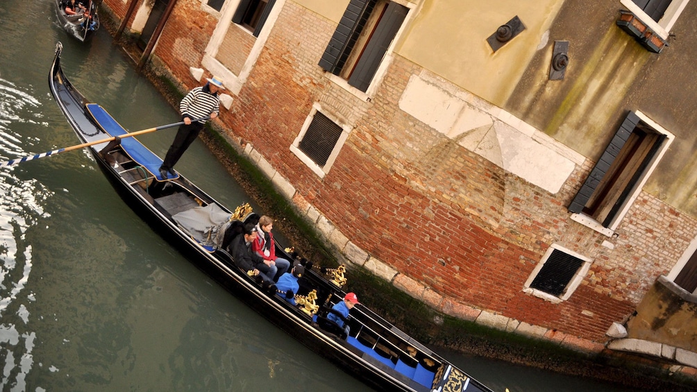 gondola turning a corner in a canal in Venice Italy