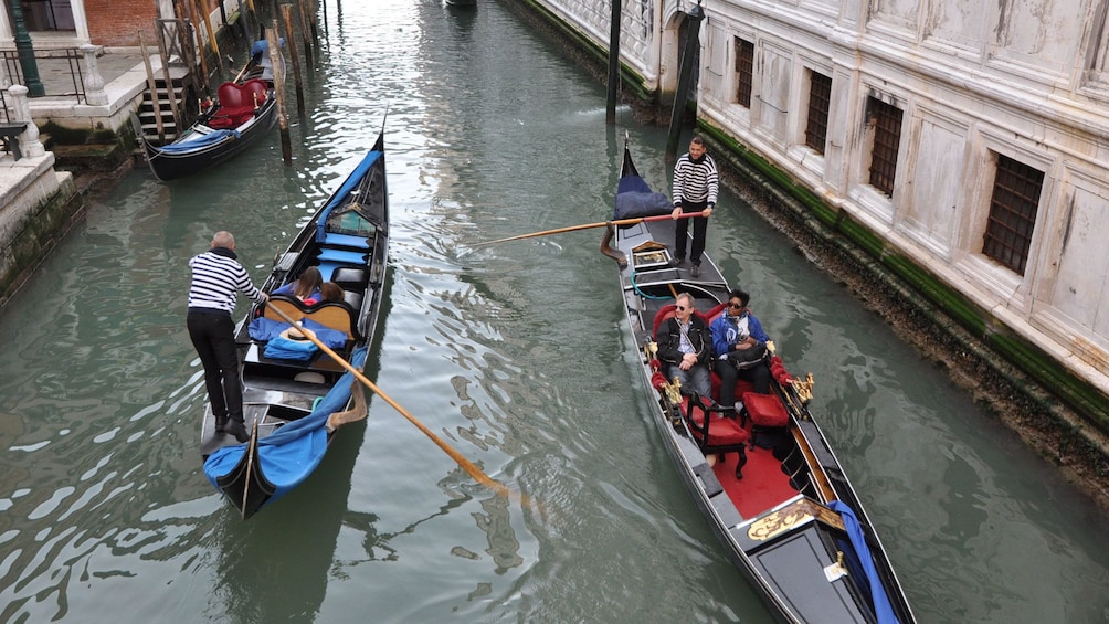 Aerial of two gondolas in a canal in Venice Italy
