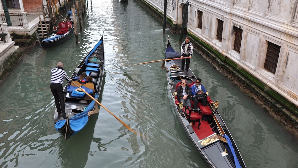 Aerial of two gondolas in a canal in Venice Italy 