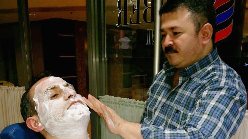 Barber putting shaving cream on a guest in Istanbul 