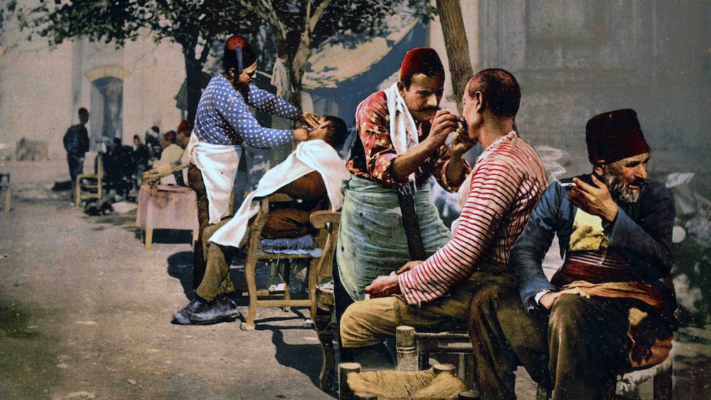 Old image of barbers giving men a traditional Turkish shave in Istanbul 