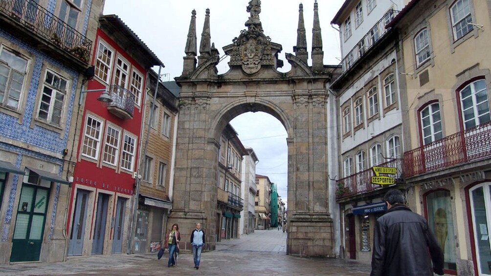 Large stone archway between buildings in Braga