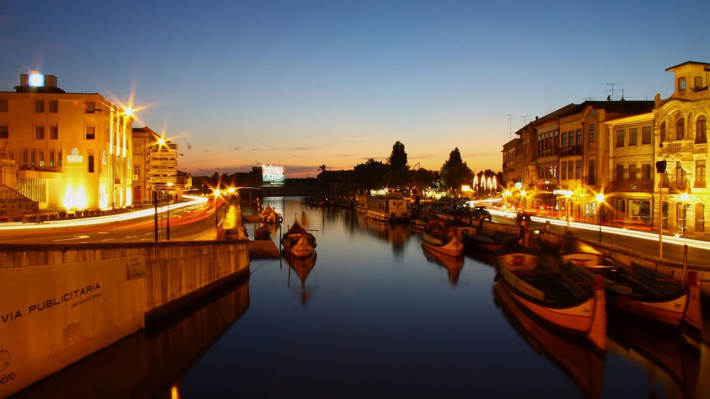 Canal and city lit up at night in Aveiro