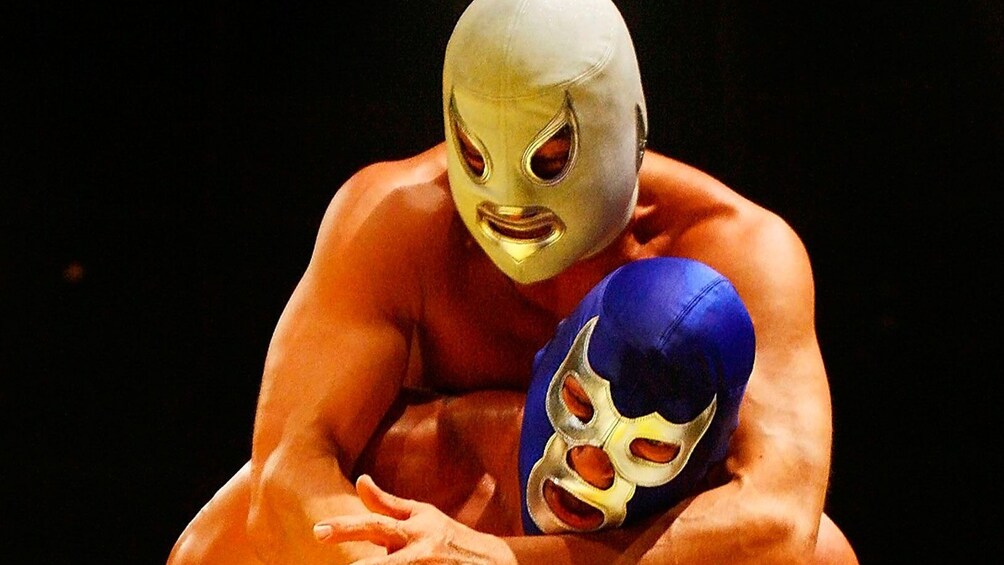 Two masked Lucha Libre fighters wrestling