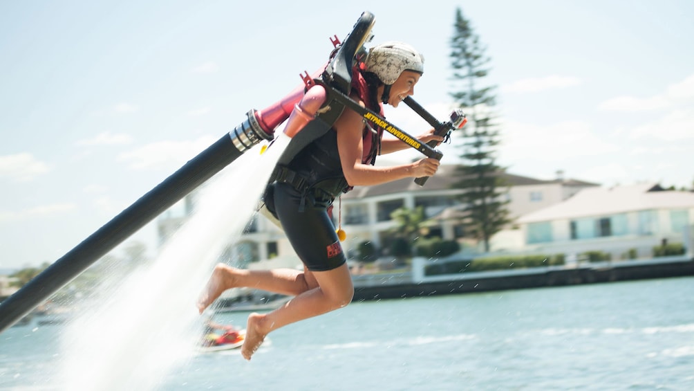 Show item 5 of 10. Woman having fun with hydro jetpack in Sydney