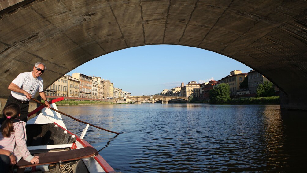 Canal view under bridge on Florence boat tour in Italy