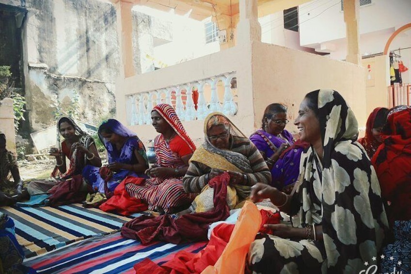 artisans in groups doing embroidery