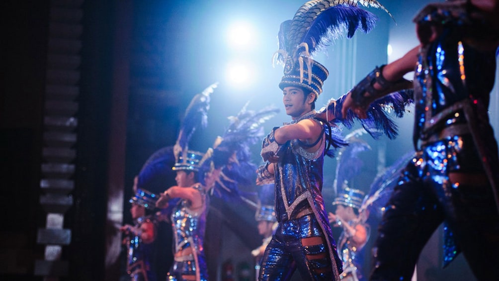 Men in costume performing on stage in Pattaya