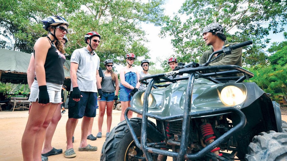 Instructor teaching a group how to ride an ATV in Phuket.