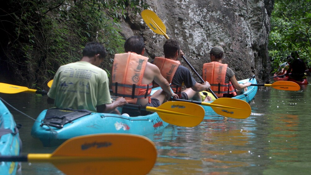 Kayakers making their way past rock formations in Ao Talen