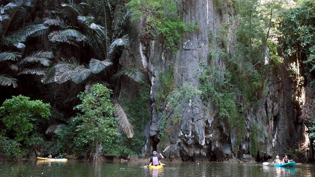 Kayakers near rocky cliffs of Ban Bor Thor