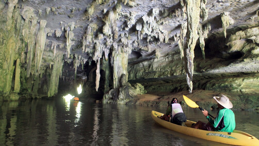 Kayakers navigating through a cave in Ban Bor Thor