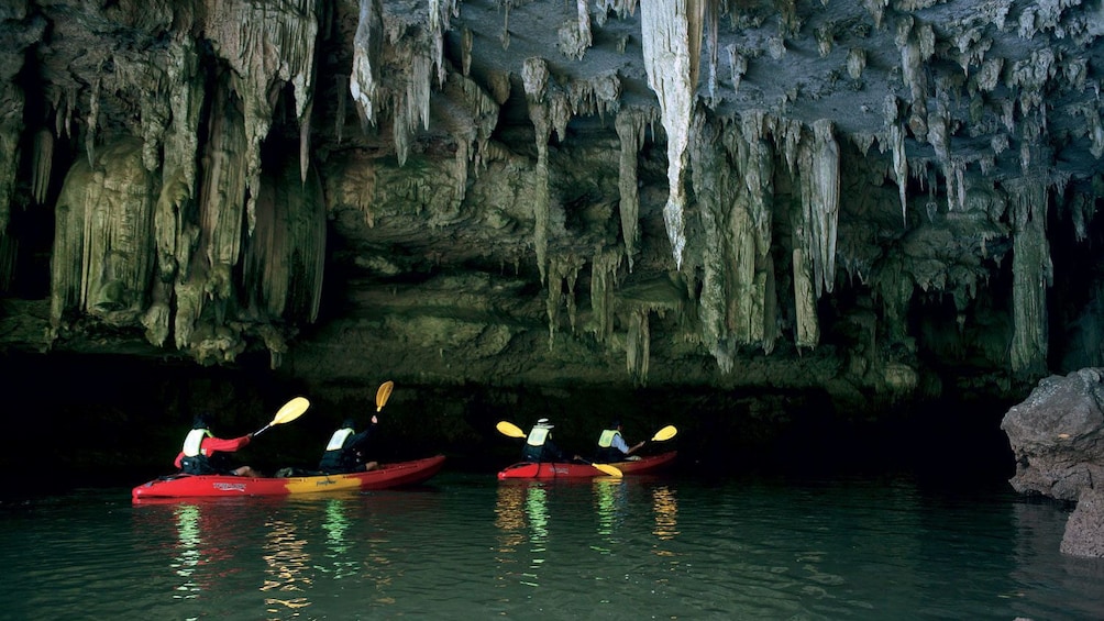 Kayakers exploring a cave in Ban Bor Thor
