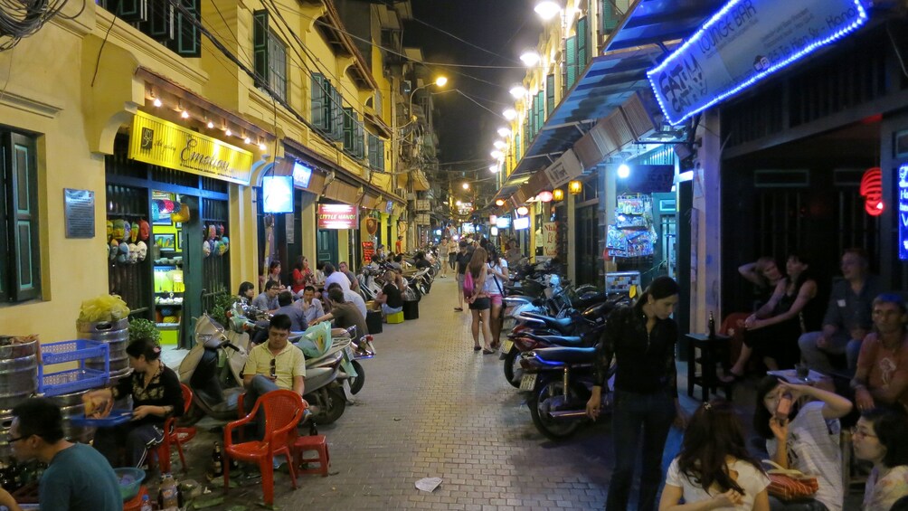 seating outside of shops at night in Hanoi