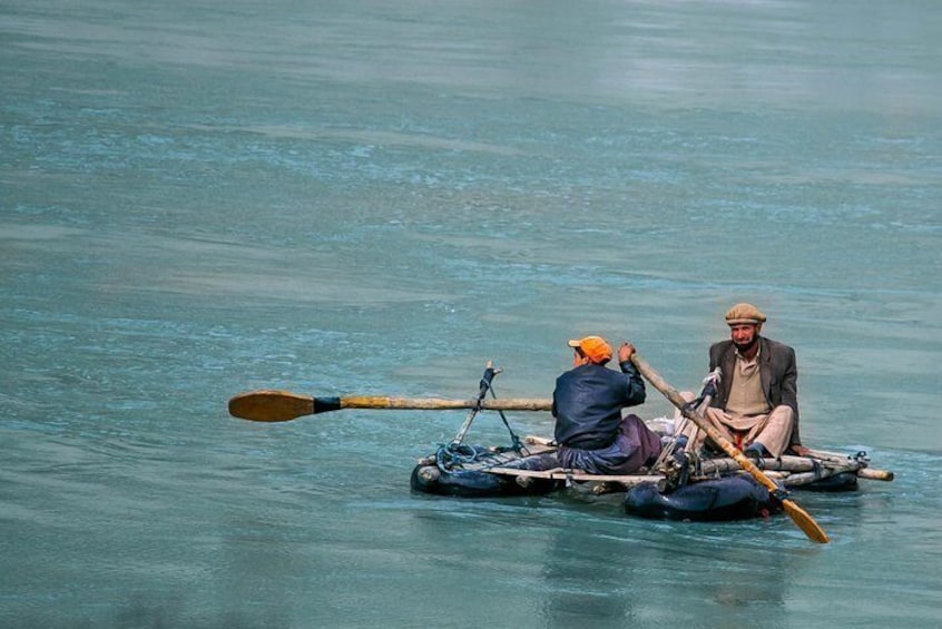 Father & son from Gulmit village crossing the beautiful Attabad Lake on their private ship