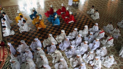 Overhead view of the monks inside the iconic Cao Dai temple in Tay Ninh Vietnam 