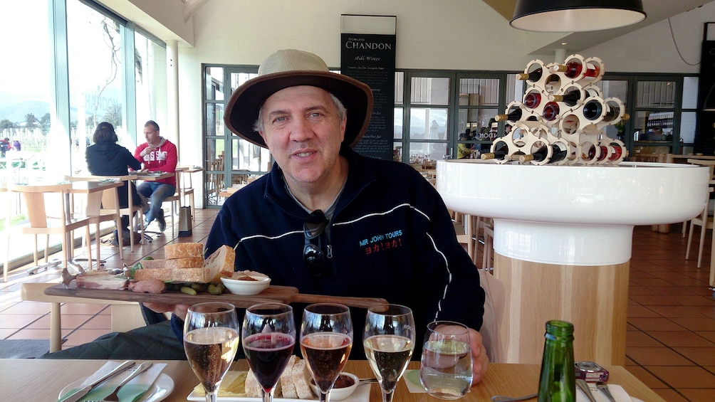 Guide holding up a platter of food at wine tasting in Melbourne