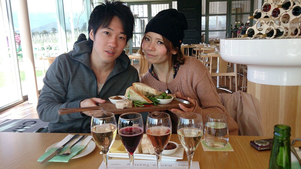 Couple enjoying lunch and wine samples in Melbourne