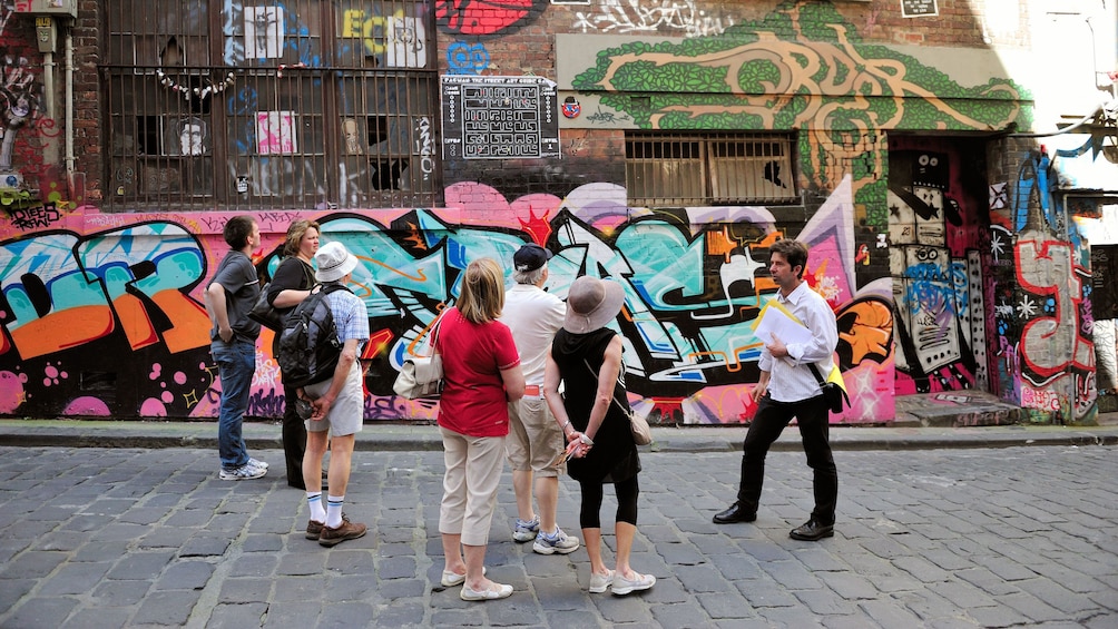 Show item 1 of 5. Visitors looking at street graffiti in Melbourne
