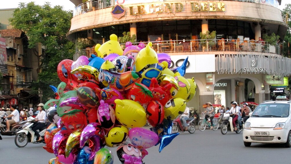 balloon vendor out on the road in Hanoi