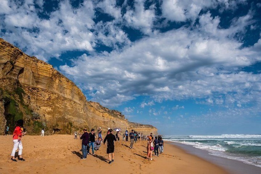 Travelers stroll along the shore at Gibson Steps, Australia.