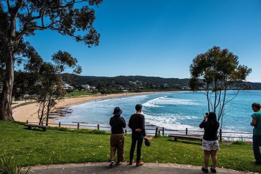 Onlookers enjoy the view of Lorne beach curving like a crescent moon in Australia.