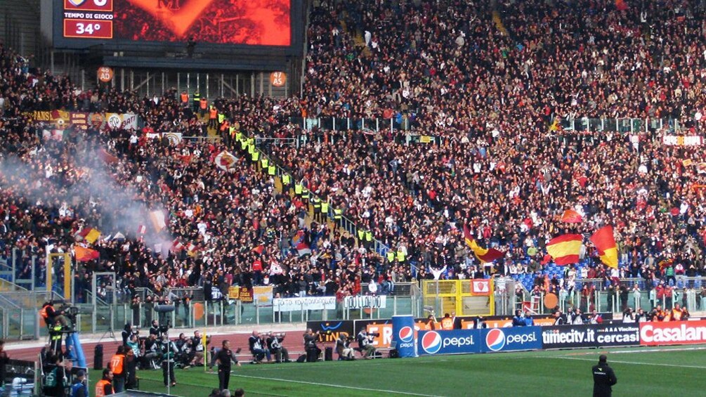 Fans cheering on their favorite team during a soccer match in Stadio Olimpico.