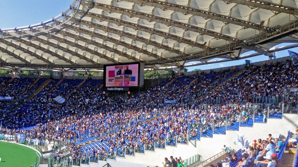 Landscape photo showcasing the grandeur of the Stadio Olimpico with fans awaiting the next soccer match.