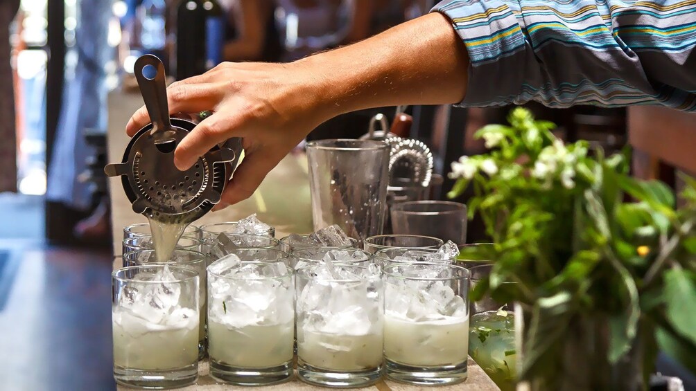 Bartender mixing drinks on the culinary tour in portland