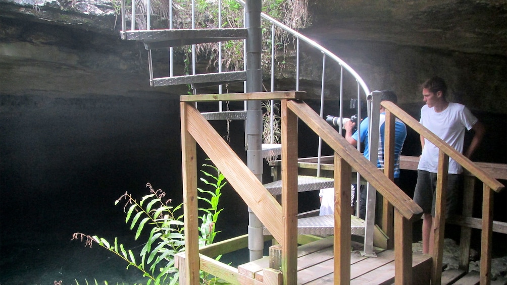 People standing on platform in cave in Lucayan National Park
