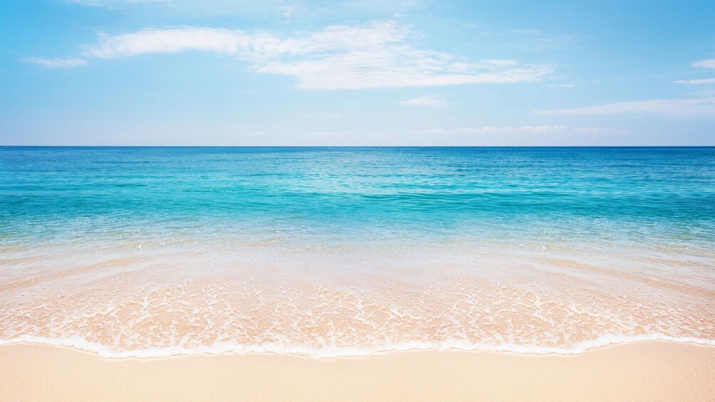 Stunning view of Gold Rock Beach's white sand and clear blue waters 