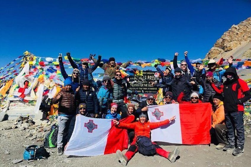 A group of Maltese having photo session after crossing Thorong La at the top. 5416 meters. 